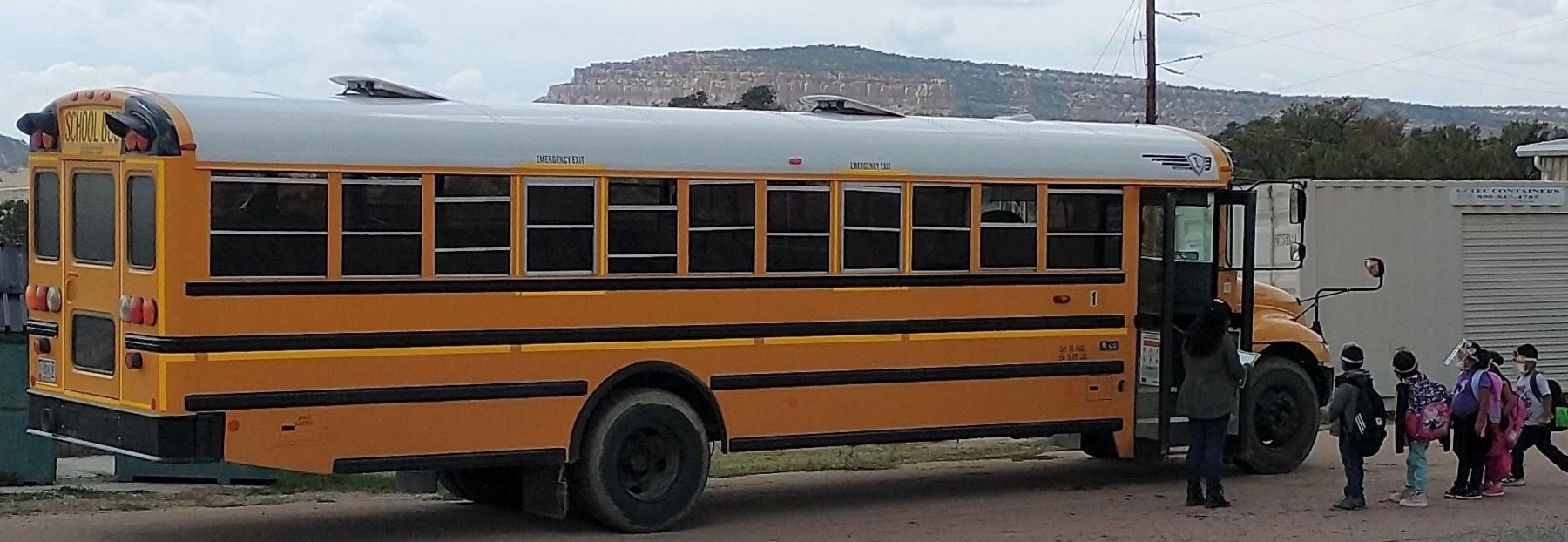Students boarding the school bus in an orderly fashion.