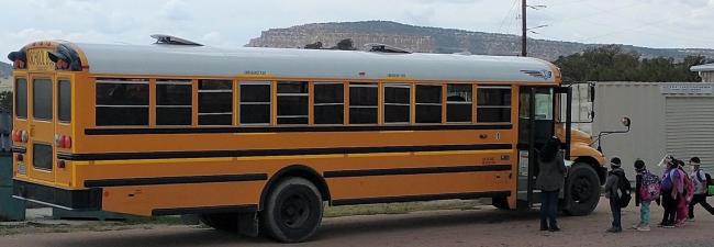 Students boarding the school bus in an orderly fashion.